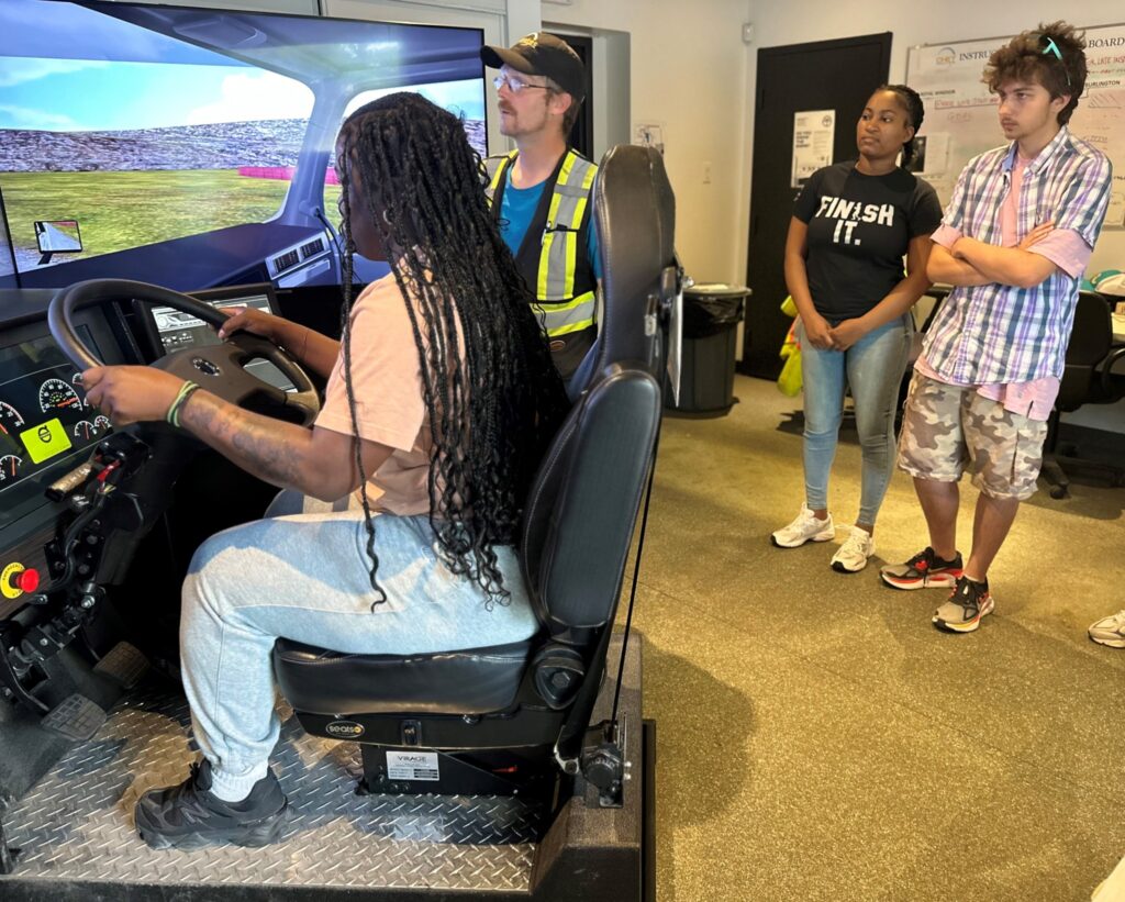 Young people trying out the truck simulator