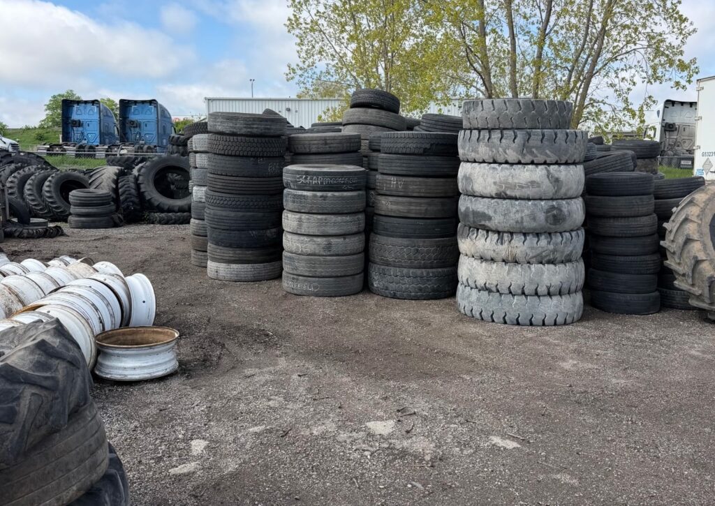 scrap tires, including commercial, pilled up in a yard