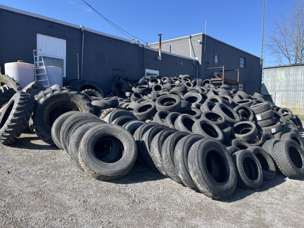 scrap tires, including commercial, pilled up in a yard