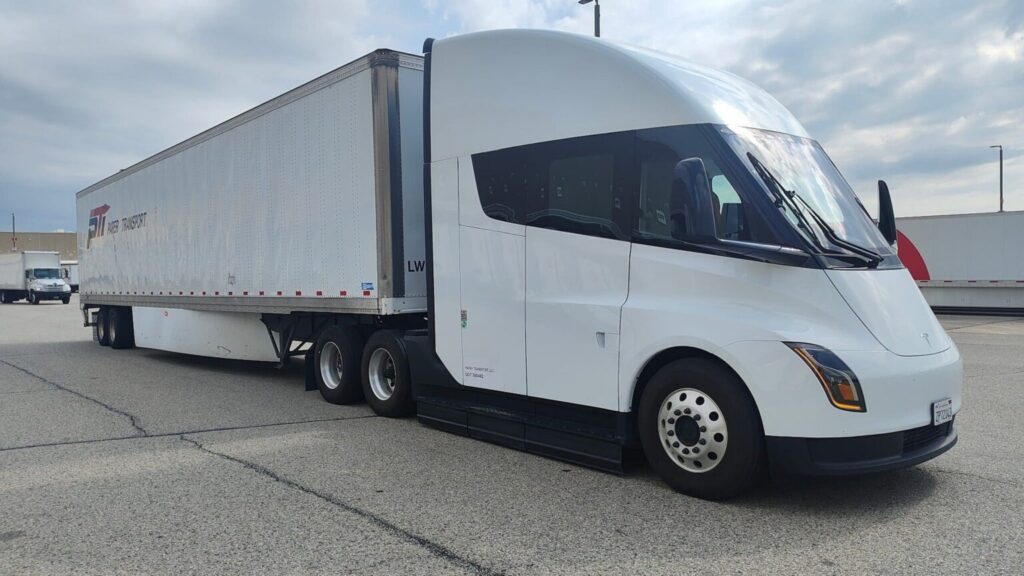 Paper Transport's Tesla Semi hooked to a PTI-branded trailer