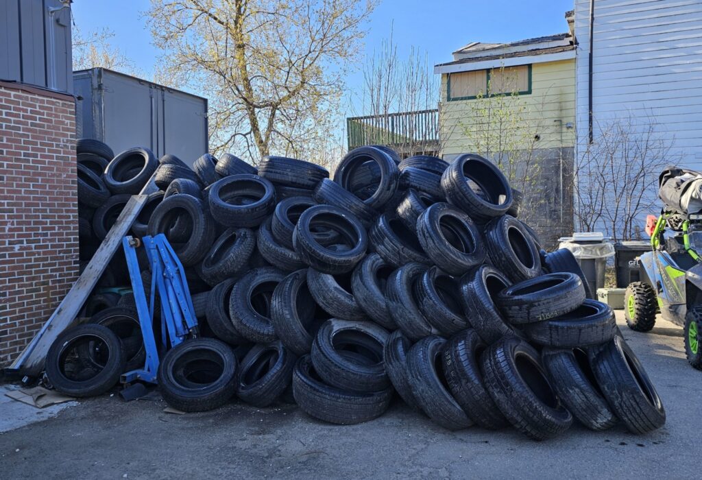 scrap tires, including commercial, pilled up in a yard