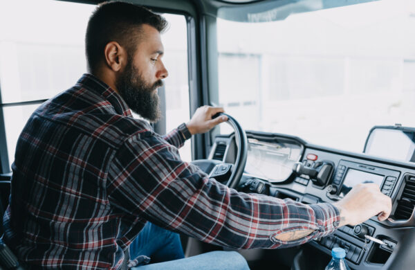 Truck driver checks his ELD.