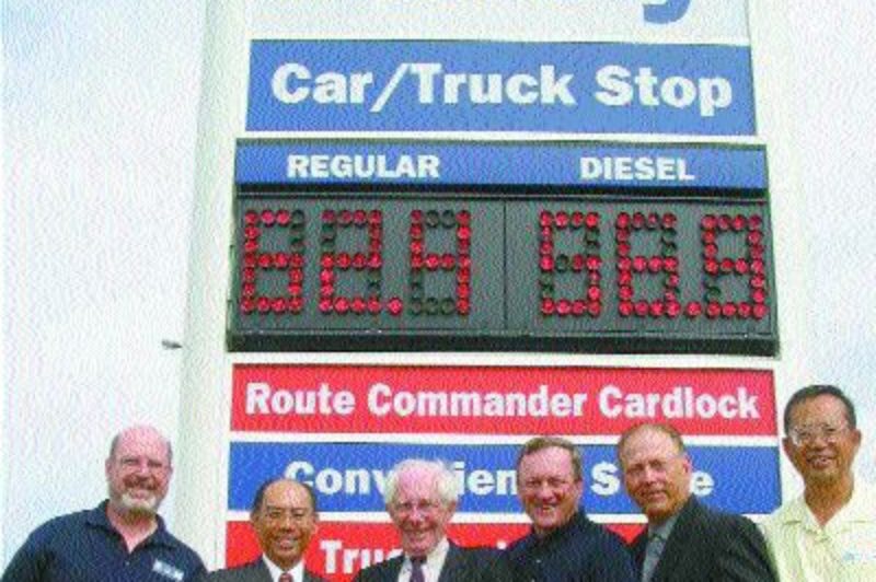 IT'S OFFICIAL: Pictured cutting the ceremonial red ribbon at the grand opening are (l to r):Bill Warner, Husky Energy; Joey Sit, HSBC; Mike Brett, Unipetro; Pierre Simard, Husky Energy; Jim Malvin, Husky Energy and Albert Chou, Unipetro.