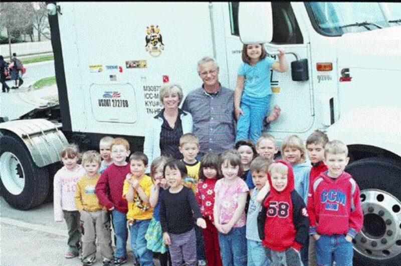 ALL SMILES: Trucker buddy Fred James is able to visit his class at the Stonemoor Day Care Centre in Port Perry, Ont. as often as once a week when he travels home to see his wife and day care supervisor, Karen. James is one of more than 80 Canadian drivers involved in the program. Photo by Adam Ledlow