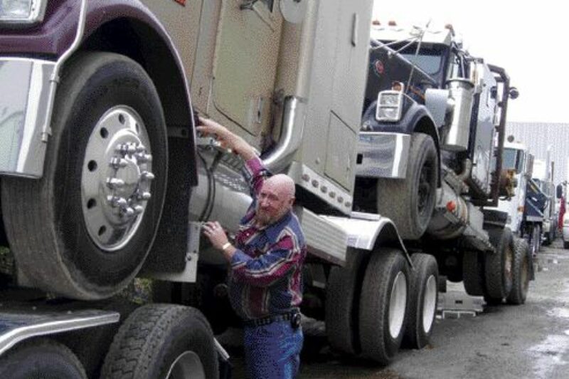 JAMAICA BOUND: Bill Jerrett of Transrite Transportation Services secures a 1987 International on its way to Jamaica, just one of many popular destinations for used Canadian trucks.Photo by Harry Rudolfs