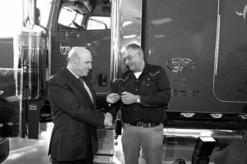 LOYALTY REWARD: TransX driver Joe Nayanokee accepts the keys to a new Pete from company president Louis Tolaini.