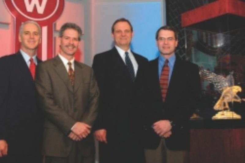 DEALER OF THE YEAR: From left are Gary Moore, Kenworth assistant general manager for marketing and sales; Ken Leach, Custom Truck Sales; Bob Christensen, Kenworth general manager; and Brent Leach, Custom Truck Sales.