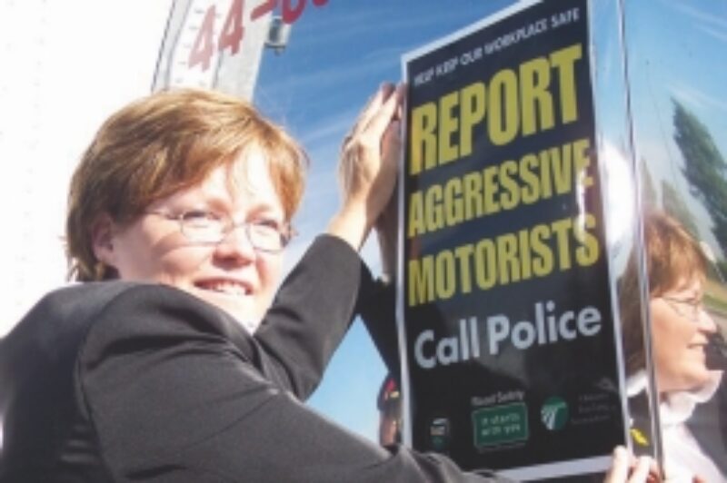 STOP AGGRESSIVE DRIVING: Debbie Virgoe, widow of heroic trucker David Virgoe, affixes the first decal to a trailer as part of a campaign to put the brakes on aggressive driving. More than 2,000 decals have been made available for truckers on a first-come, first-served basis.