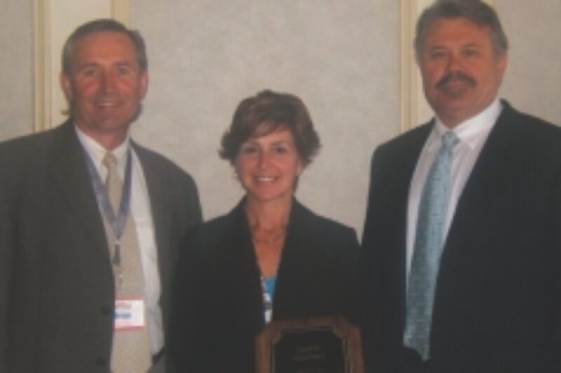 LESS THAN 100 UNITS: Brian Taylor and Theresa Barclay of Liberty Linehaul accept their retention award from Nevio Turchet of SelecTrucks Canada.