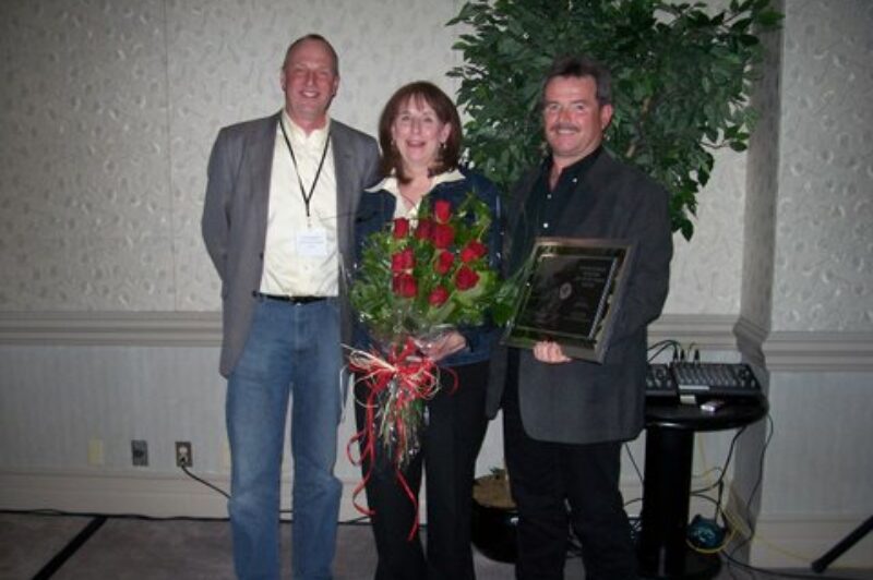 AMTA Driver of the Year Pat Thorne (right) and his wife Cheryl receive the award from Terry Warkentin, fleet sales manager, Volvo Trucks Western Canada.