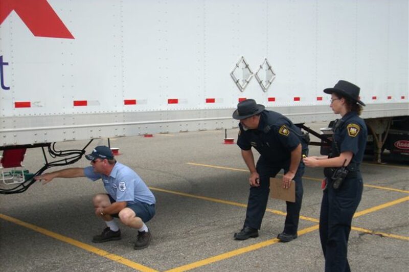 A driver completes an inspection under the watchful eyes of inspectors during the Toronto Regional Truck Driving Championships.