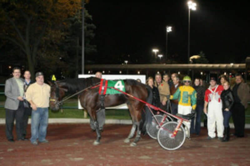 Kevin Burch (far left) presented the winning trophy to the owner of Caviar's Dream following the first ever Truckload Carriers Association Race held at Woodbine.