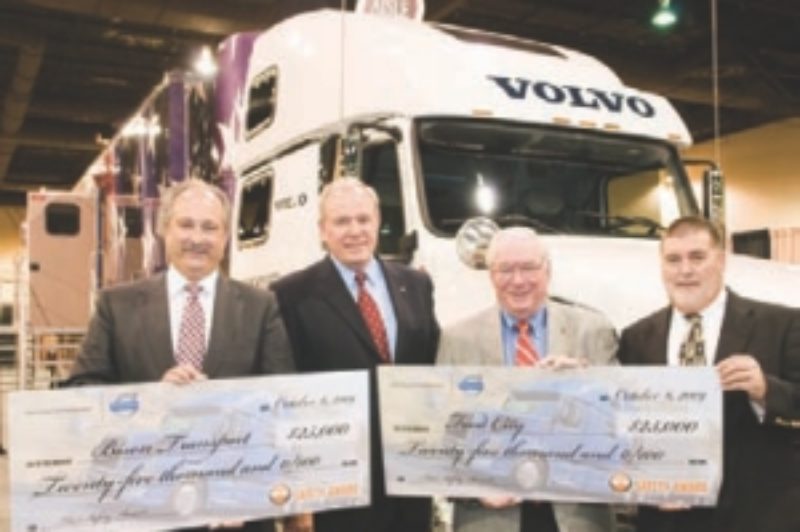 SAFETY PAYS: Bison Transport president Don Streuber (left) collects the cash from Volvo exec Scott Kress in recognition of its safety practices.