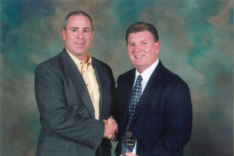 Doug Frank, general manager, logistics shared services, Schneider Logistics (left) presented the award to Jeff Lewis, manager, corporate accounts, TST Overland Express.