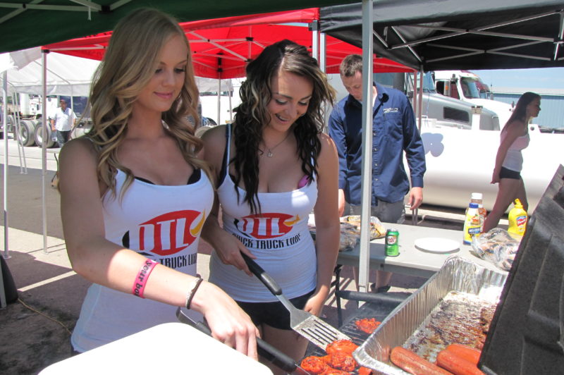 HOT STUFF: A pair of helpers work the grill at Quick Truck Lube's sixth annual customer appreciation BBQ. In addition to a free lunch, customers also took advantage of a $99 oil change.