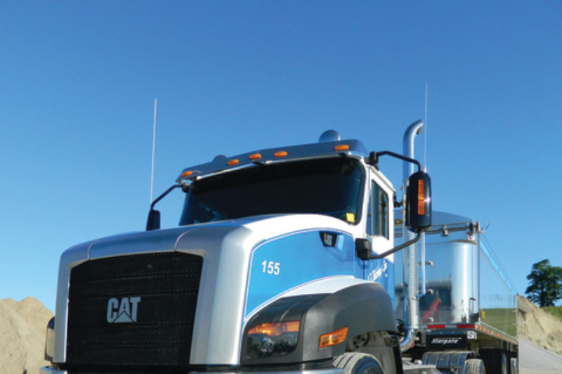 CANADA'S CAT: J.F. Kitching & Son of Queensville, Ont. has been running this Cat CT660 - the first in Canada - all summer. The only drawback, its driver says, is that productivity has been reduced because everyone wants to take a peek inside whenever the truck is stopped. Photo by James Menzies