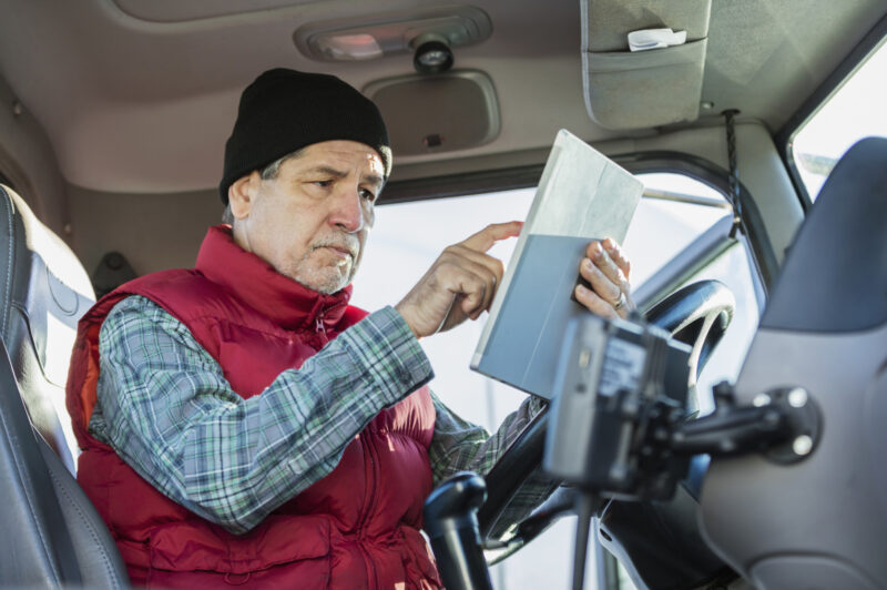 older truck driver in cab
