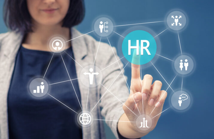 Businesswoman pressing human resources button on digital touch screen. Human resource management concept.