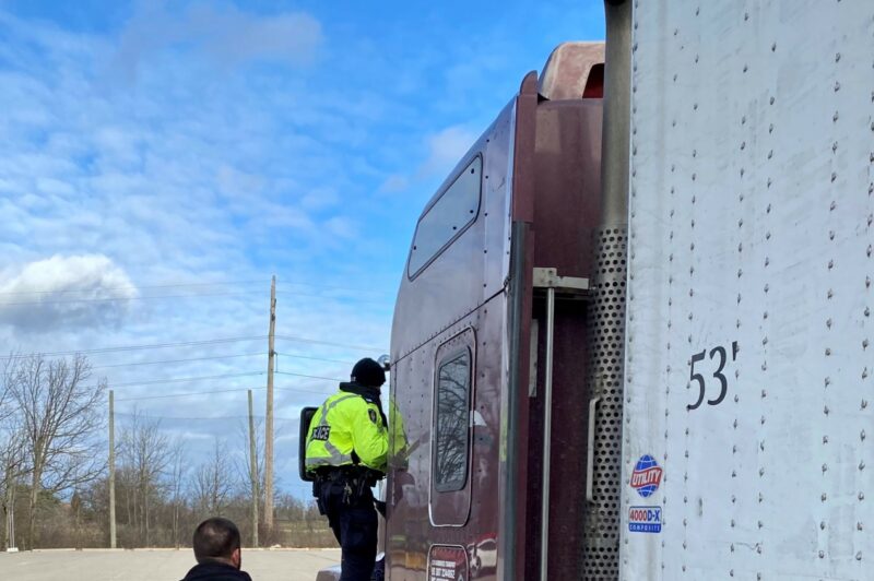 Police officers inspecting a truck