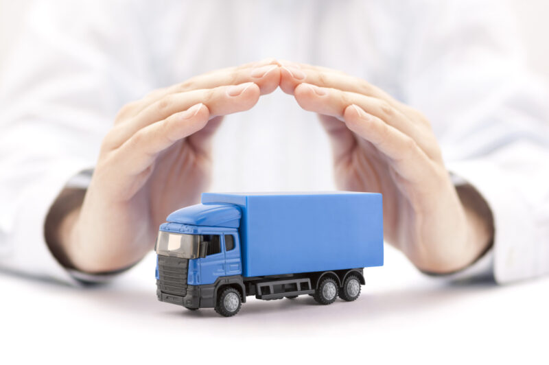Two hands covering a miniature truck