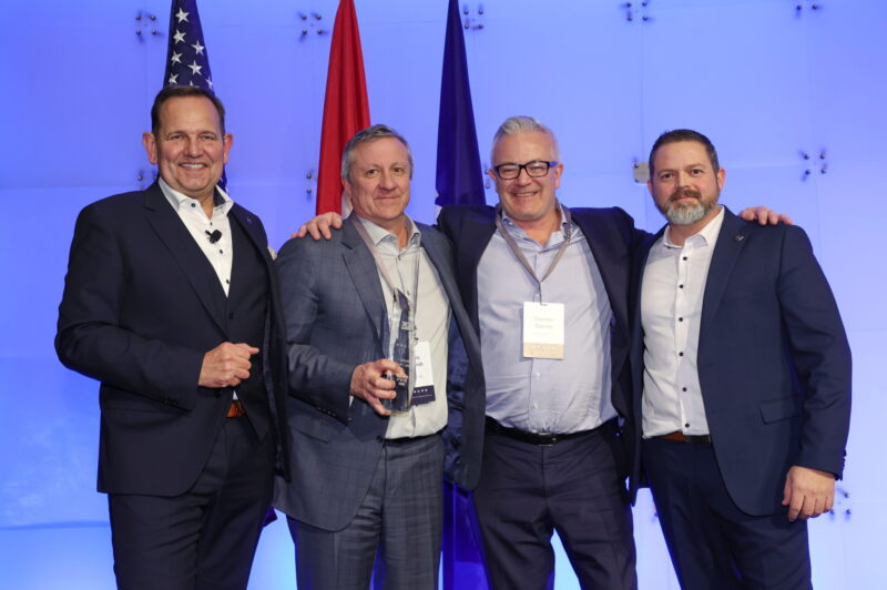 Four men with an award