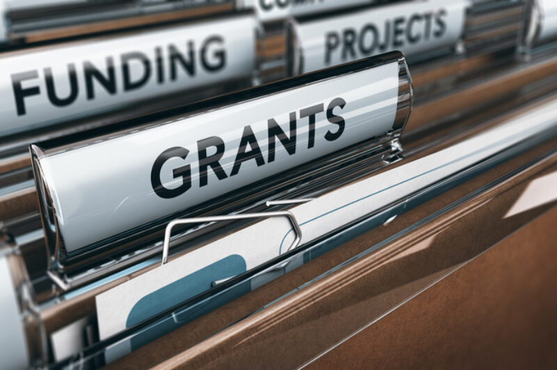 View of brown folders, with focus on grants label, Concept of funding, 3D illustration