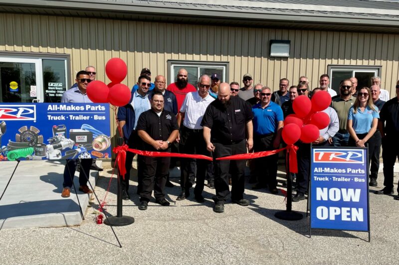 A man cuts a ribbon
