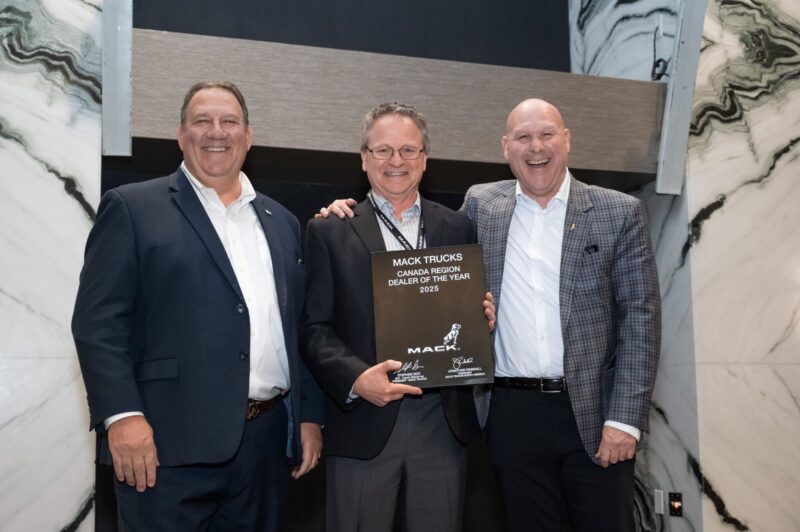 Picture of three men with a trophy