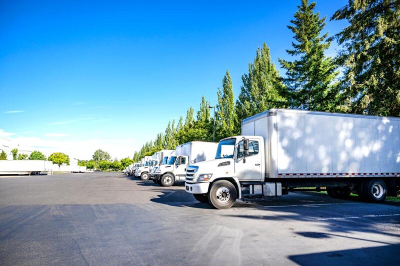 AdobeStock_1333624384 industrial box trucks parked in a row