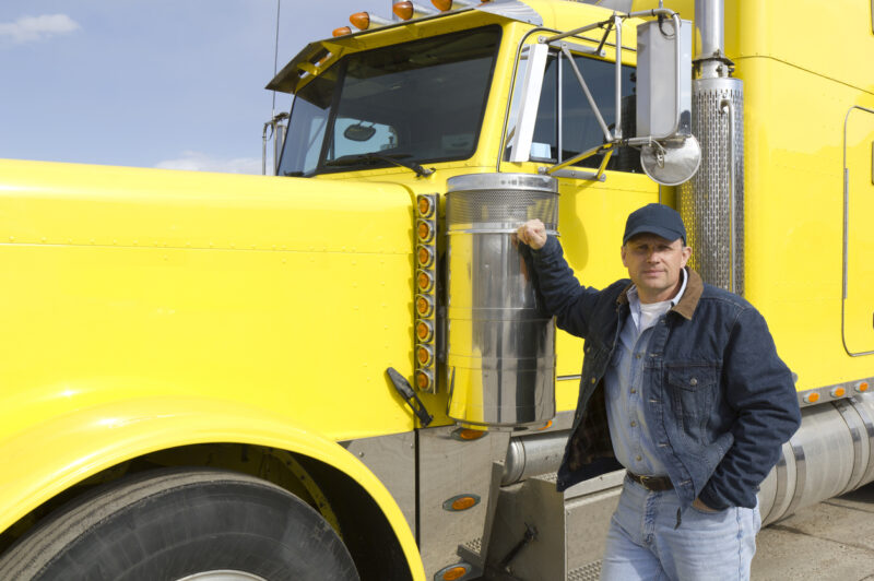 Truck driver by his truck.