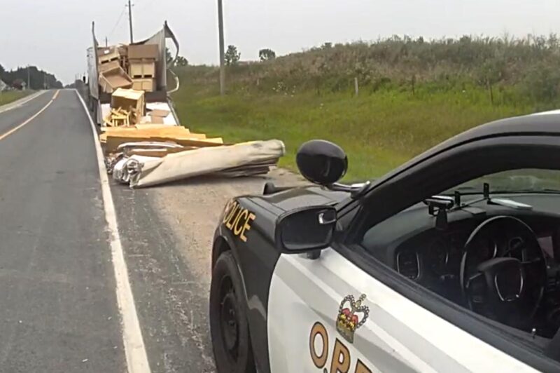 Picture of a damaged tractor trailer after it hit a train bridge